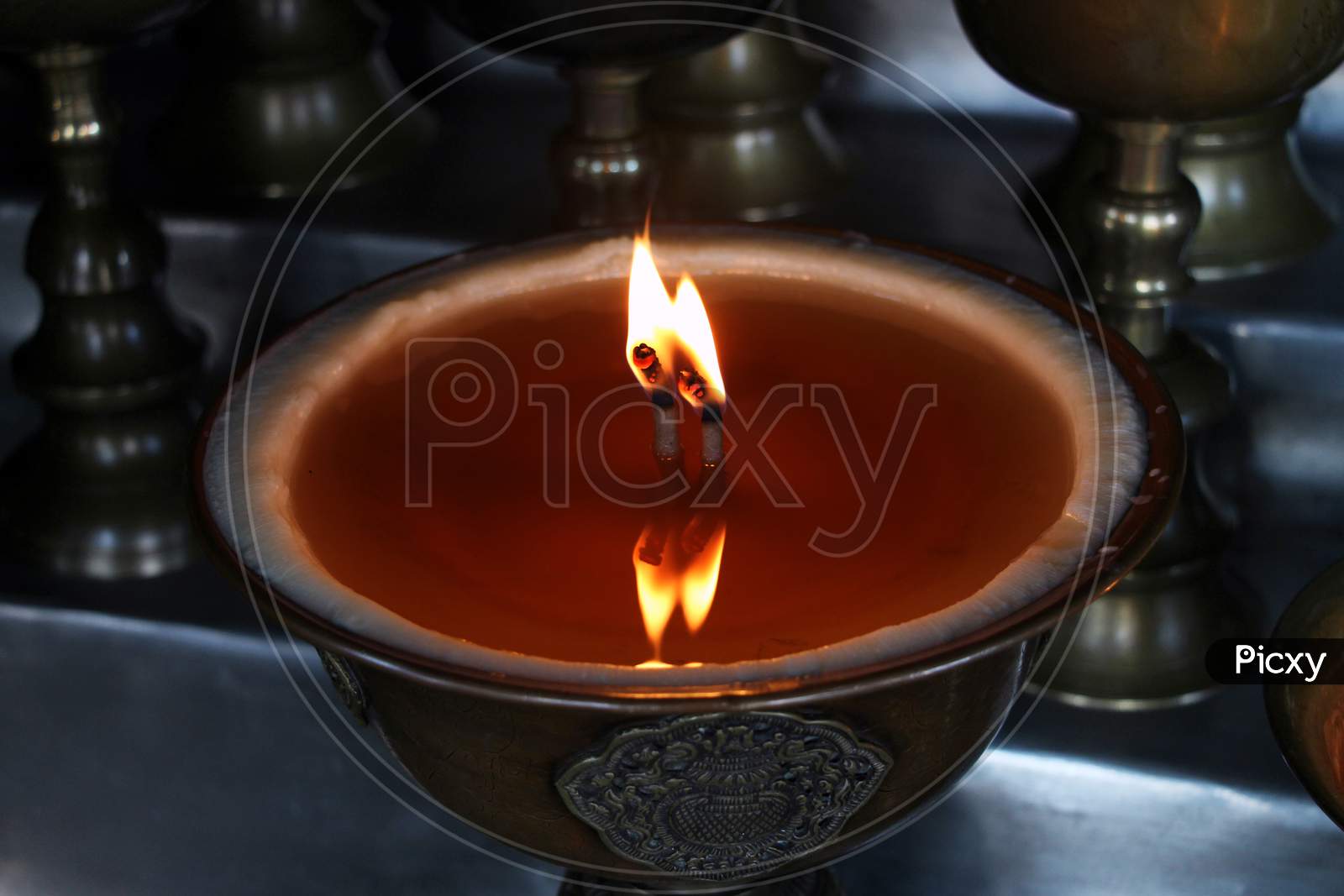Close up shot of Lighted Diya Placed in a Sequence