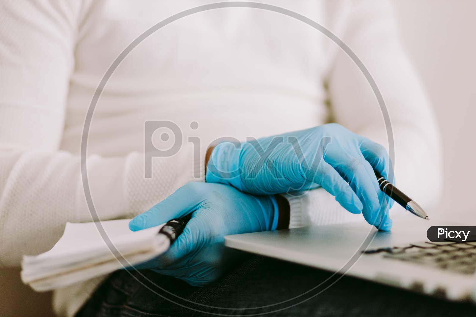 Man Using Laptop And Wearing Latex Gloves At Home Quarantine