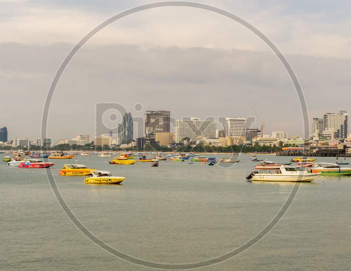 Pattaya,Thailand - April 20,2018: The Beach Tourists Relax And Swim There And Rent Boats For Trips.Some Thai People Sell Souvenirs,Food And Drinks To Them.