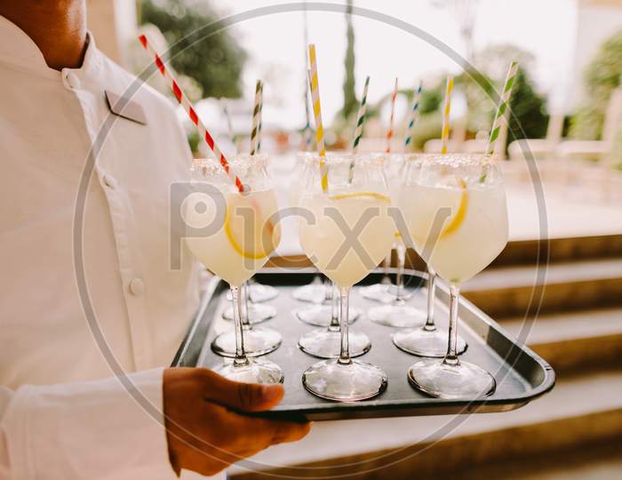 Waiter Holding Glasses With Cocktail Hot Summer