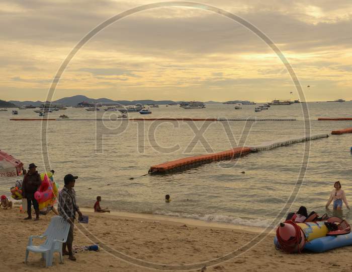 Pattaya,Thailand - April 29,2018: The Beach Tourists Relax And Swim There And Rent Boats For Trips.Some Thai People Sell Souvenirs,Food And Drinks To Them.