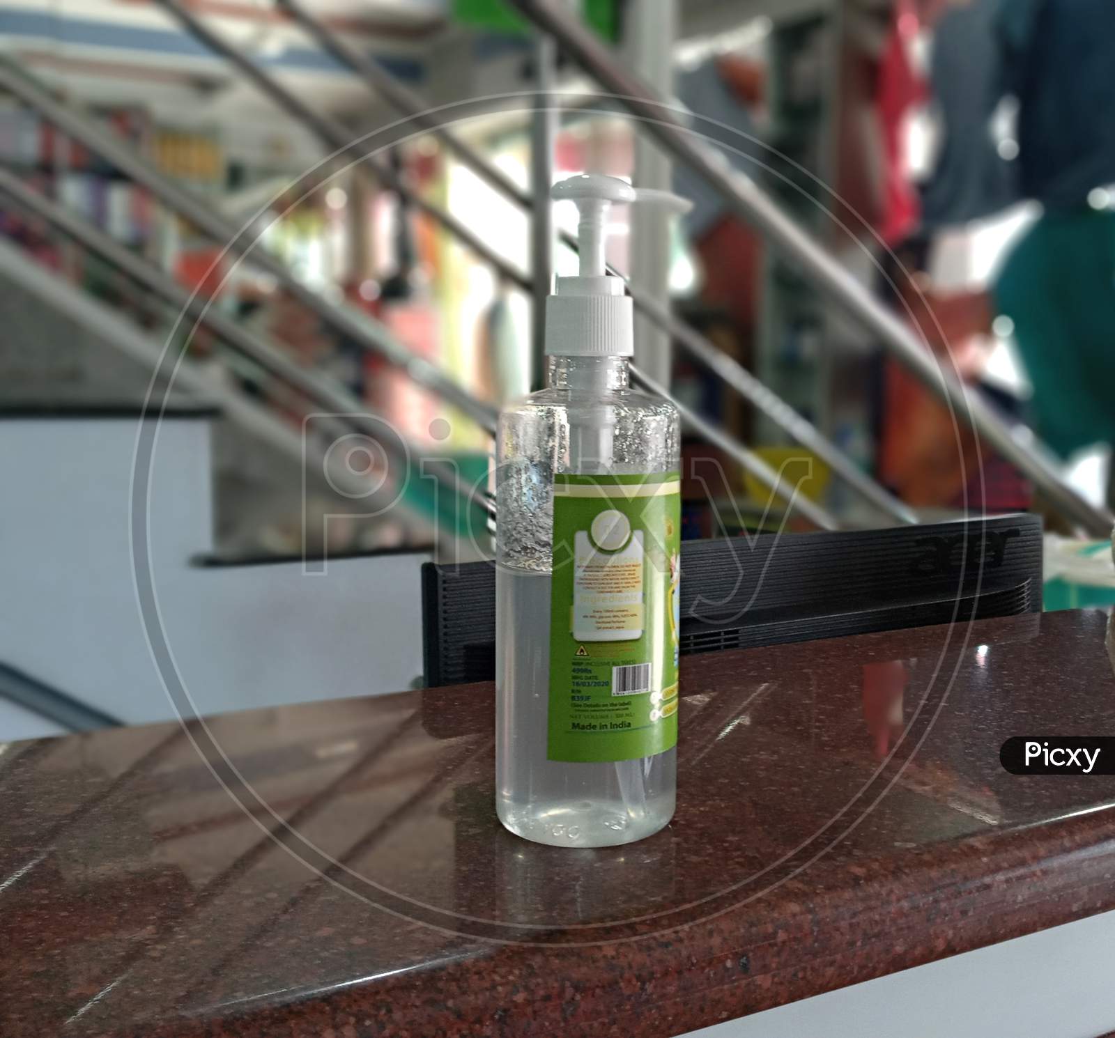 Hand sanitizer kept on top of shop counter for customers to sanitize their hands