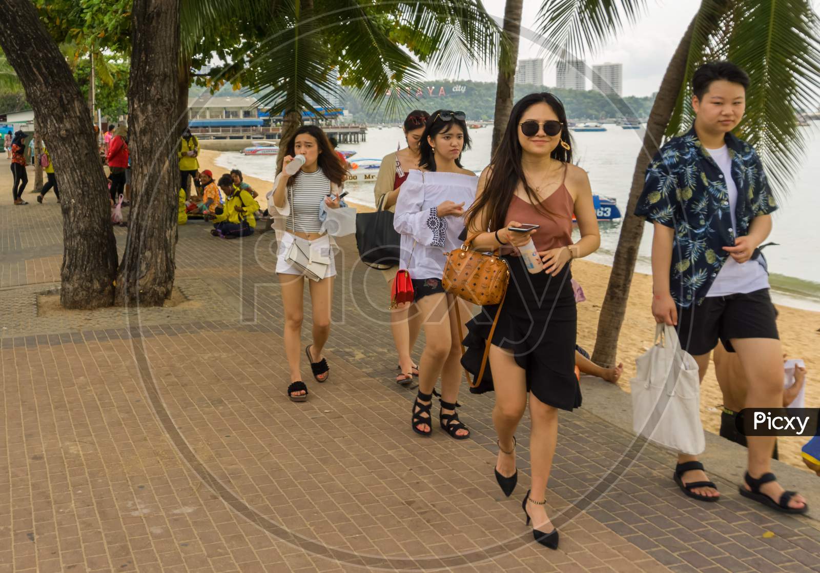 Pattaya,Thailand - April 17,2018: The Beach Many Tourists From China Relax And Swim There And Rent Boats For Trips.Some Thai People Sell Souvenirs,Food And Drinks To Them.