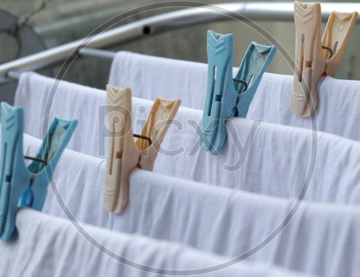 White Clothes Drying On Standing Clotheshores With Clothespins White Inner Wear On Rack Dryer Collapsible Clothes Horse With Clothes Plastic Clothespins