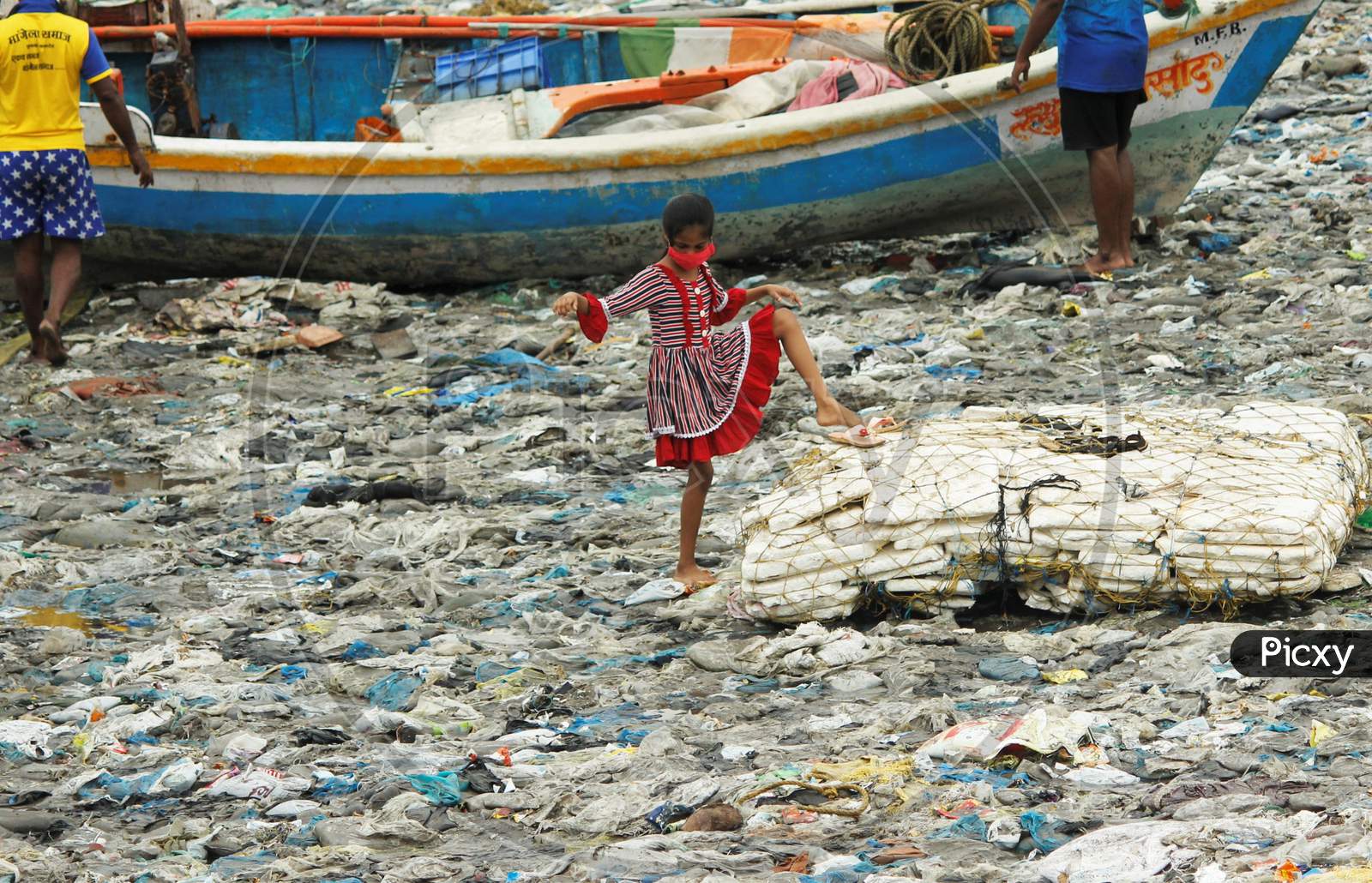 A girl plays on a beach covered with plastic waste on the occasion of World Environment Day, in Mumbai, India on June 5, 2020.