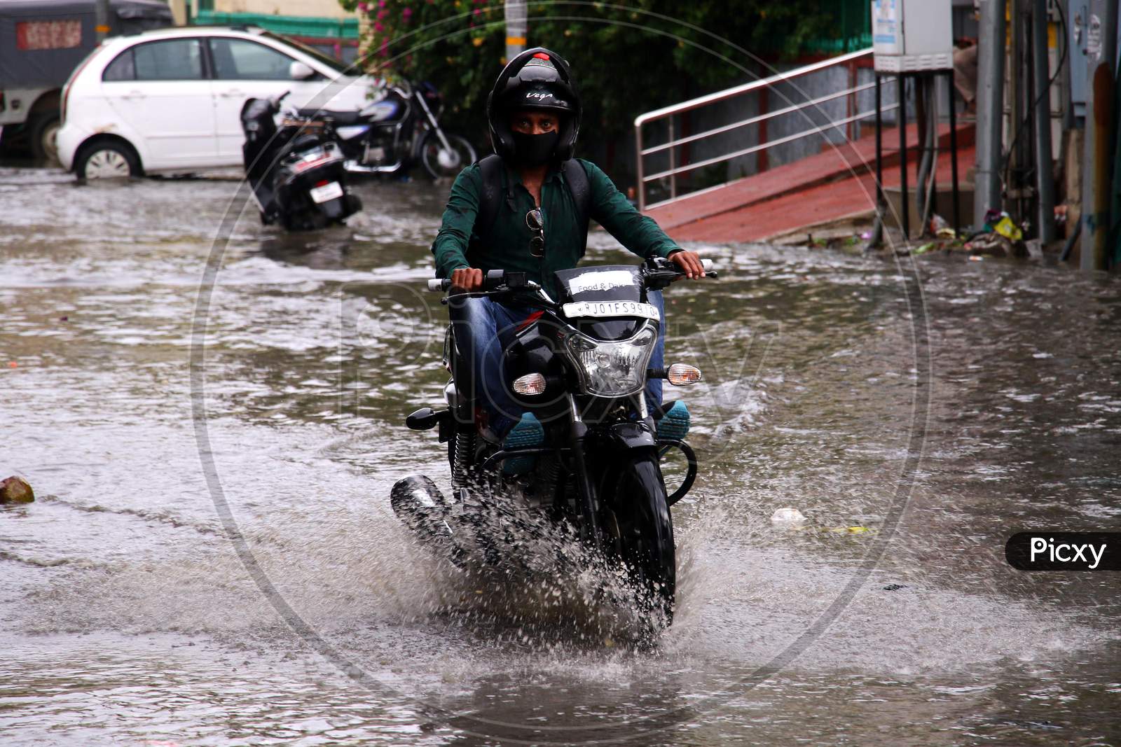 A Bike Rider  On A Waterlogged Road During Rain, In Ajmer, Rajasthan, India On 04 June 2020.