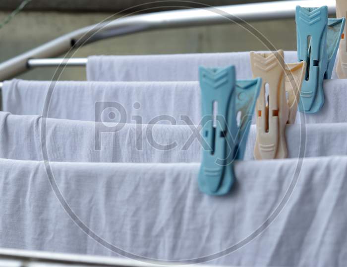 White Clothes Drying On Standing Clotheshores With Clothespins White Inner Wear On Rack Dryer Collapsible Clothes Horse With Clothes Plastic Clothespins