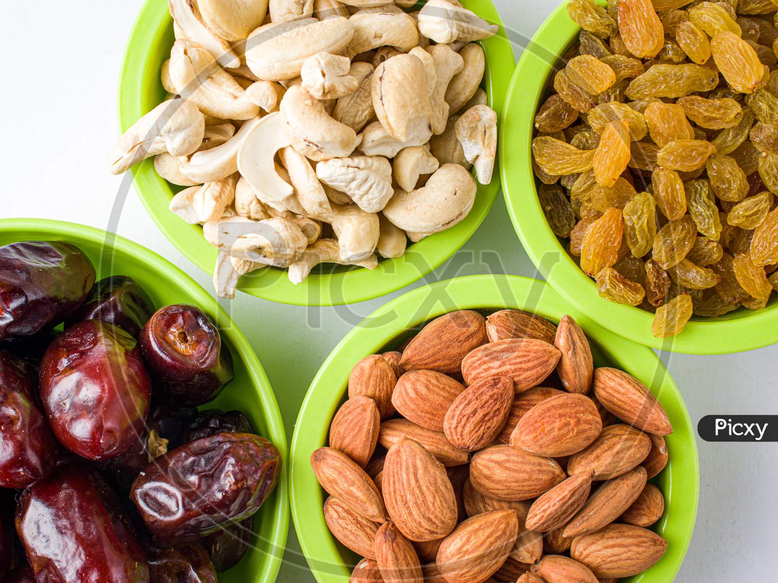 khajur, raisin/kismis, kaju badam/ cashew and almonds all at a single frame stock image white background.