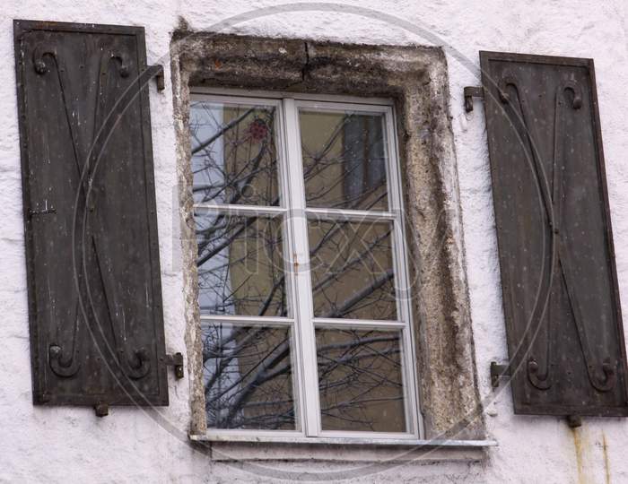 Medieval Window Of Building With Iron Shades