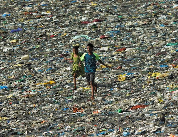 Kids run on a beach covered with plastic waste, on world environment day, in Mumbai, India on June 5, 2020.