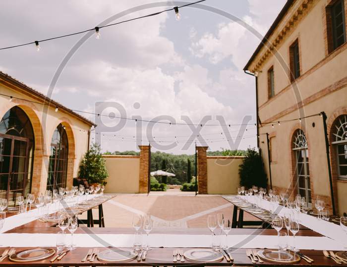 Event Table Coverage Outdoors With Plates And Glasses
