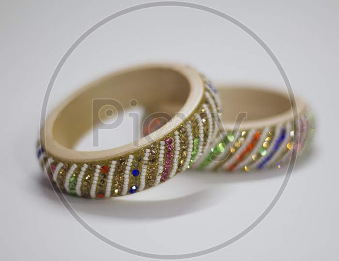 Close Up Of Pair Of Bangles Isolated On White Background With Space For Text