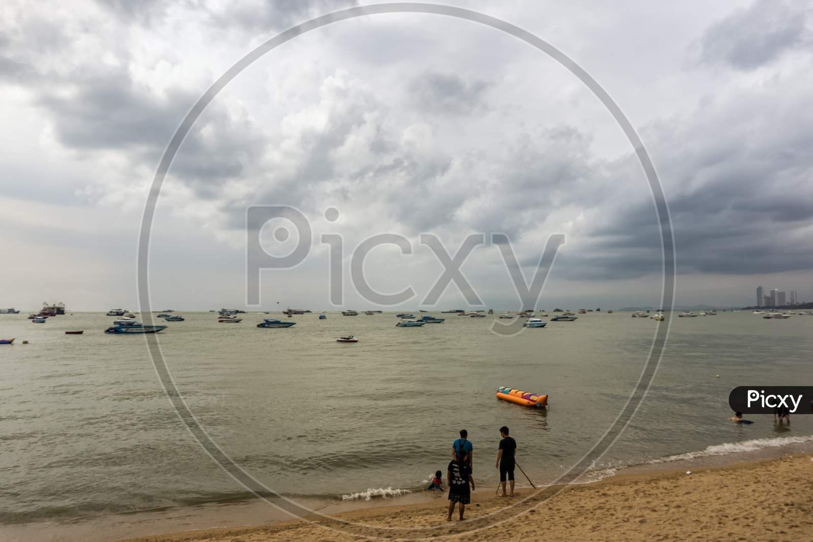 Pattaya,Thailand - April 17,2018: The Beach Tourists Relax And Swim There And Rent Boats For Trips.Some Thai People Sell Souvenirs,Food And Drinks To Them.