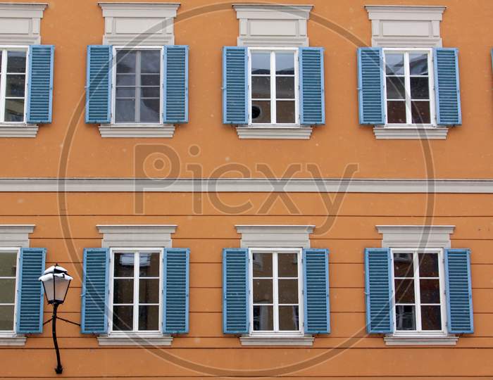 Many Identical Windows On Orange Building Facade