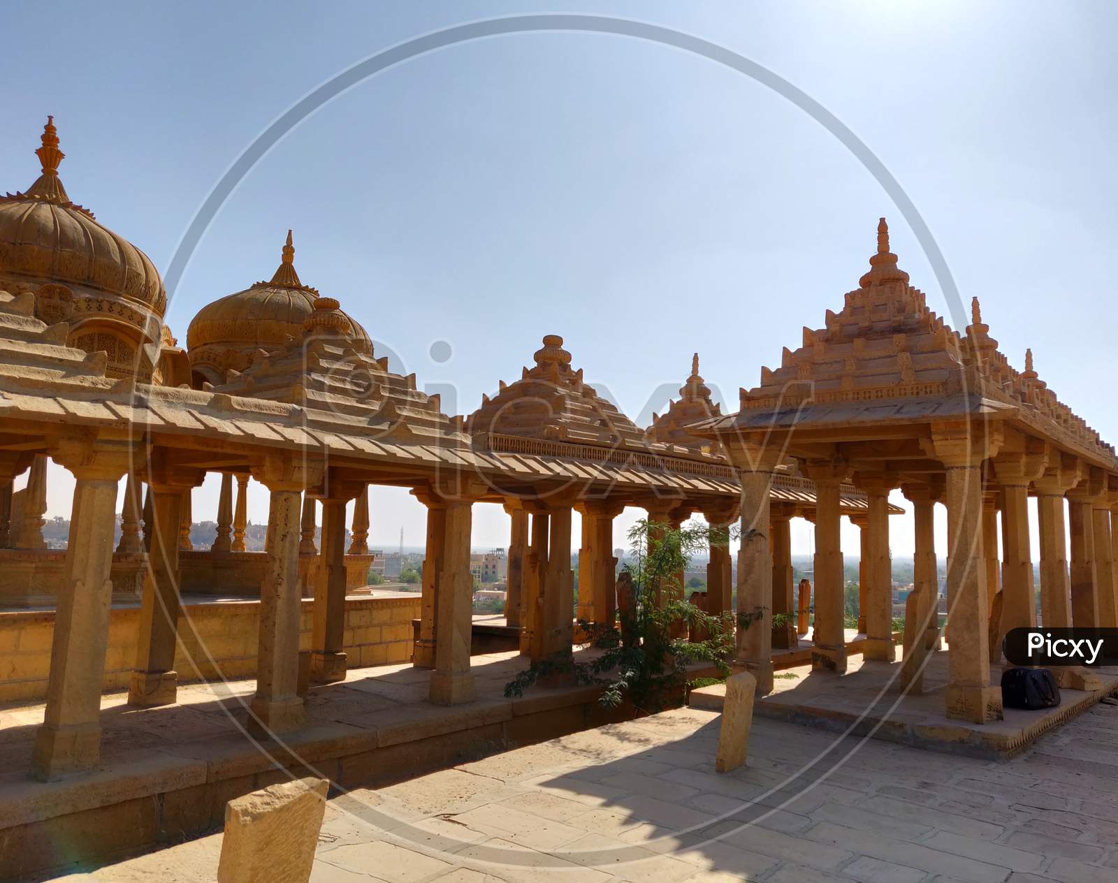 The royal cenotaphs of historic rulers, also known as Jaisalmer Chhatris, at Bada Bagh in Jaisalmer made of yellow sandstone at sunset