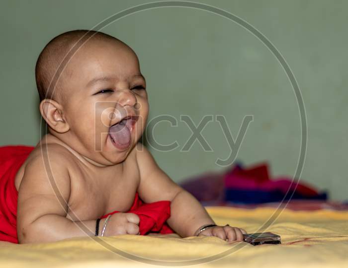 Baby Infant Cute Innocent Smiling Facial Expression With Blurred Background