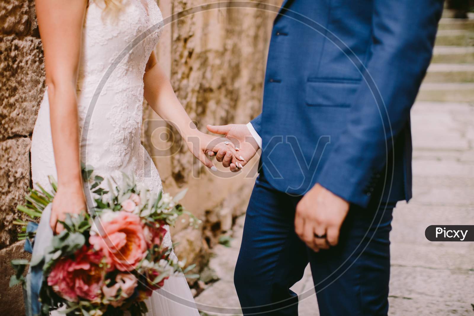 Wedding Couple Holding Hands With Engagement Ring