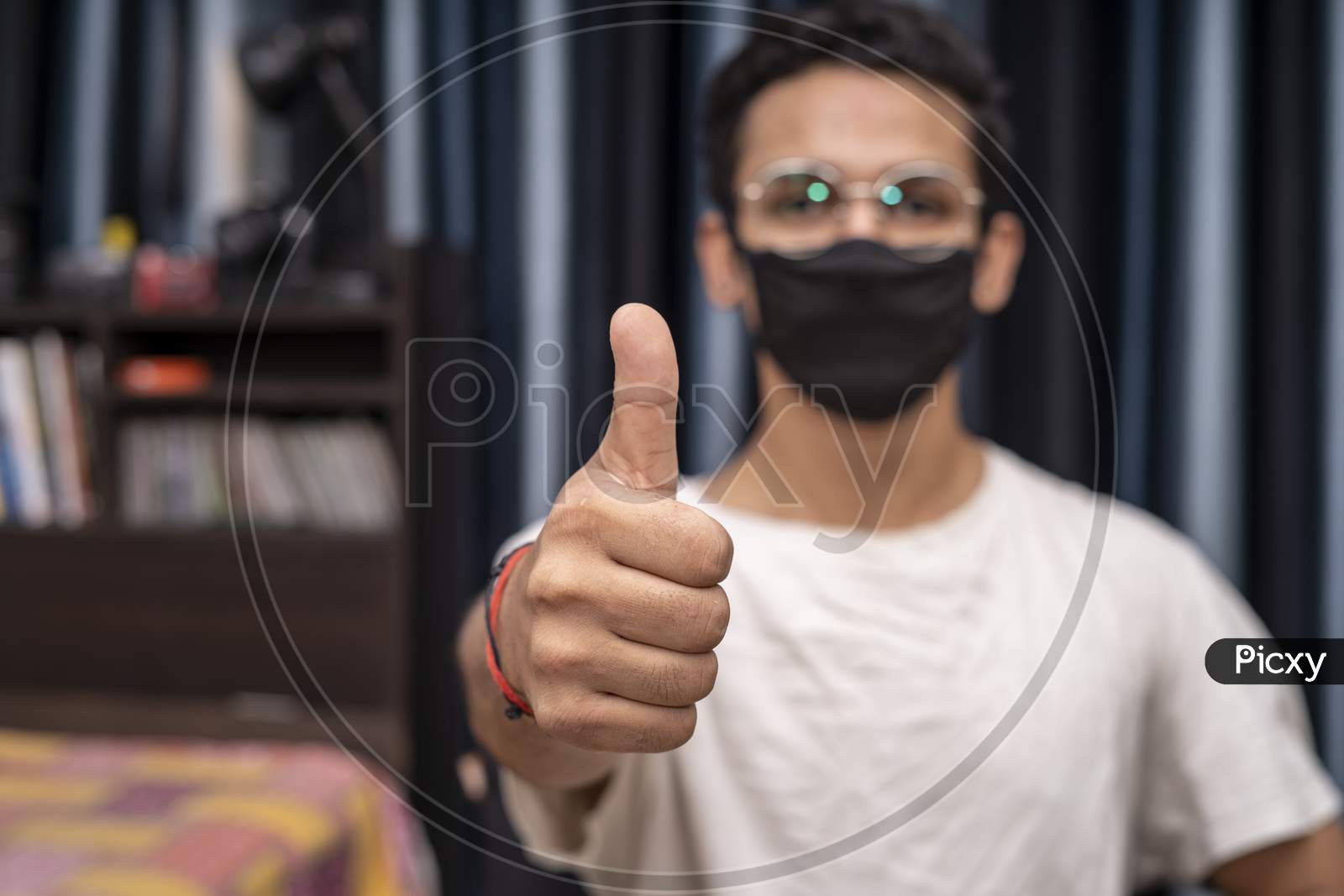 Young Indian Boy Wearing Glasses And A Black Mask Showing Thumbs Up