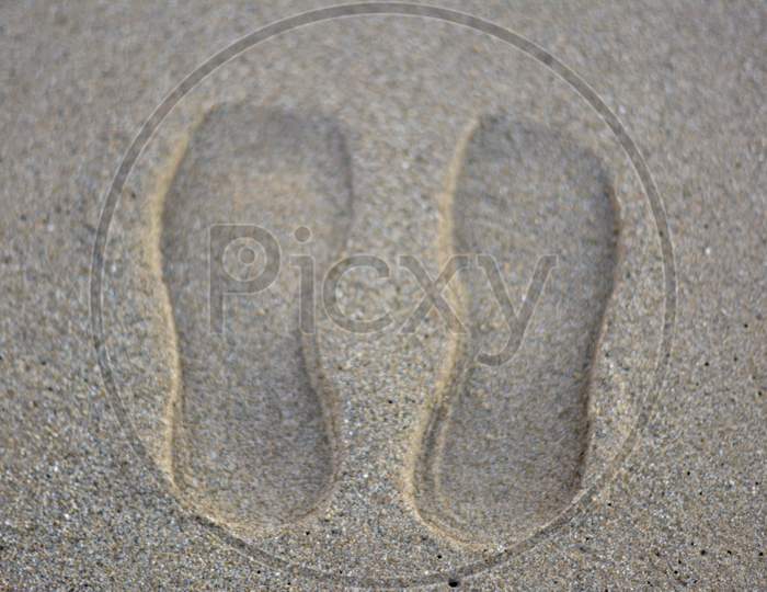 shoes print on sand beach