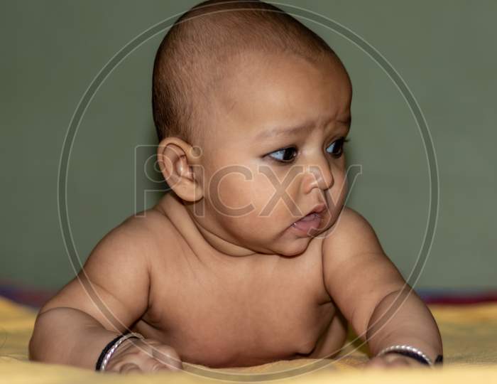 Baby Infant Cute Innocent Facial Expression With Blurred Background