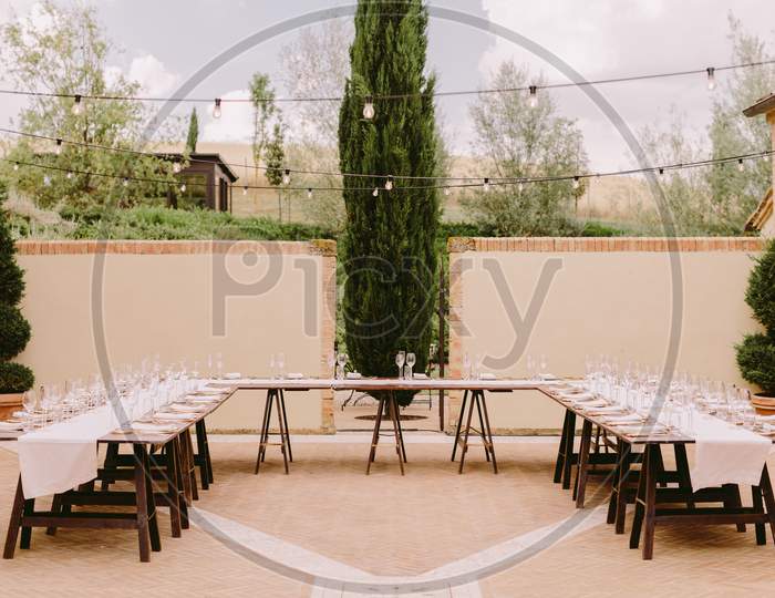 Event Table Coverage Outdoors With Plates And Glasses
