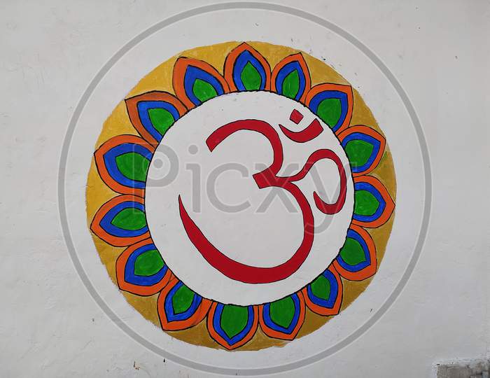 Close up view of Ohm and Swasatik symbol printed on wall.