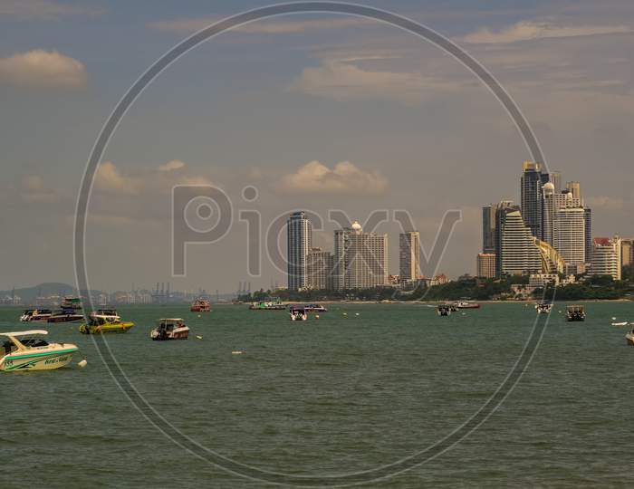 Pattaya,Thailand - October 17,2019: The Beach Tourists Relax And Swim There And Rent Boats For Trips.Some Thai People Sell Souvenirs,Food And Drinks To Them.