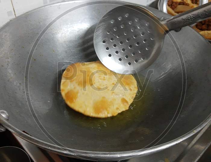 Fried Puri In A Frying Pan. Very Popular Street Food In India.Famous Indian Food, Selective Focus On Subject
