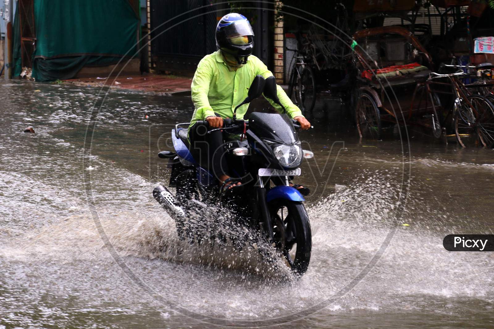 A Bike Rider  On A Waterlogged Road During Rain, In Ajmer, Rajasthan, India On 04 June 2020.