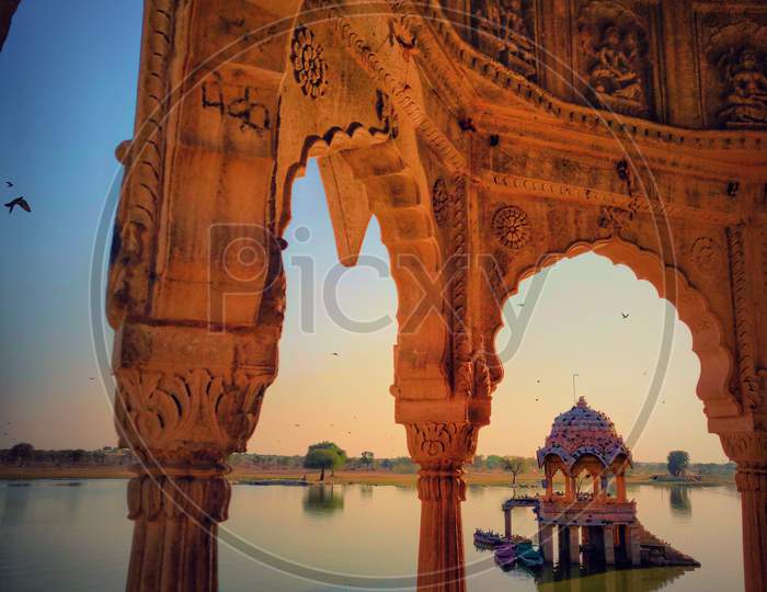 Gadi Sagar Lake Jaisalmer Rajasthan with ancient architecture at sunrise. A popular tourist destination in Rajasthan, India.