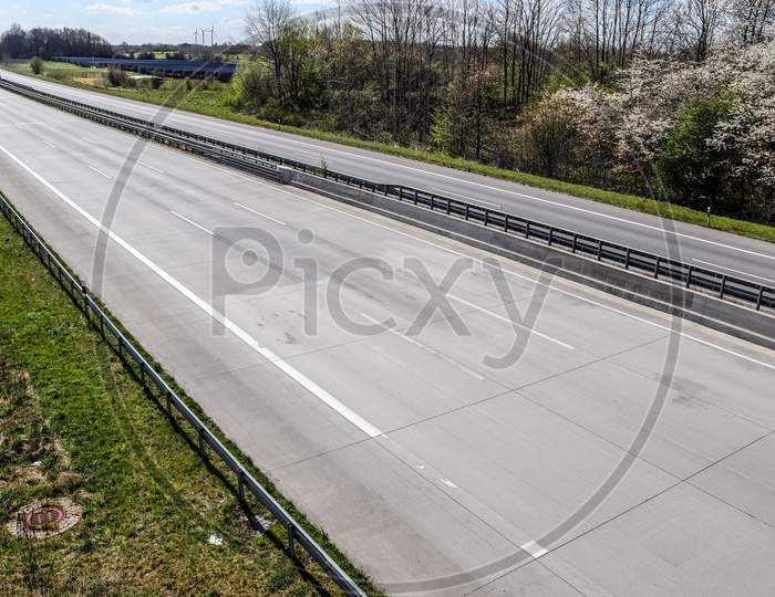 erspective view on an empty european highway on a sunny day during corona