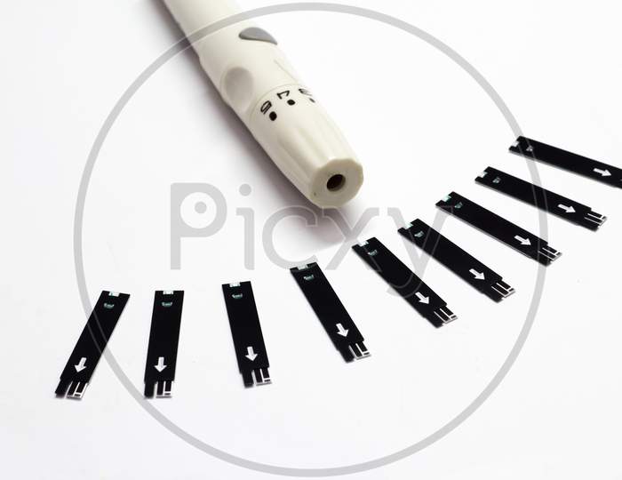 Close Up Of Diabetes Lancet Pen And Blood Glucose Test Strip For Checking Blood Sugar Level, Medicine, Diabetes Health Care