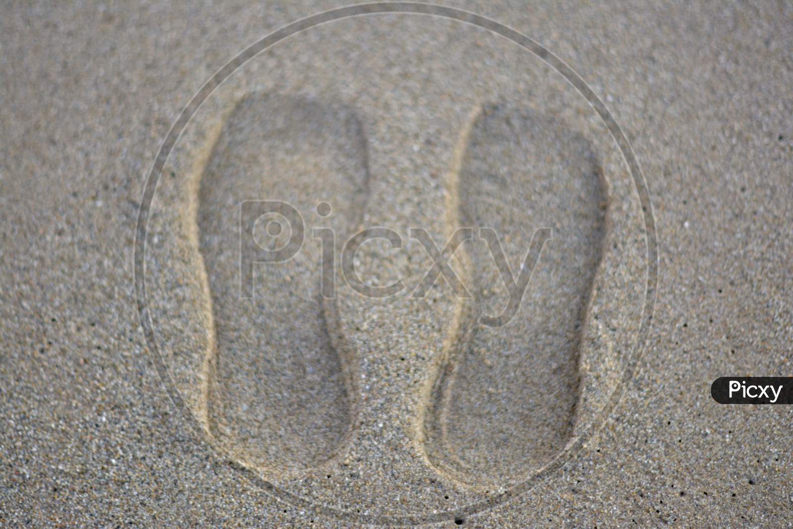 shoes print on sand beach