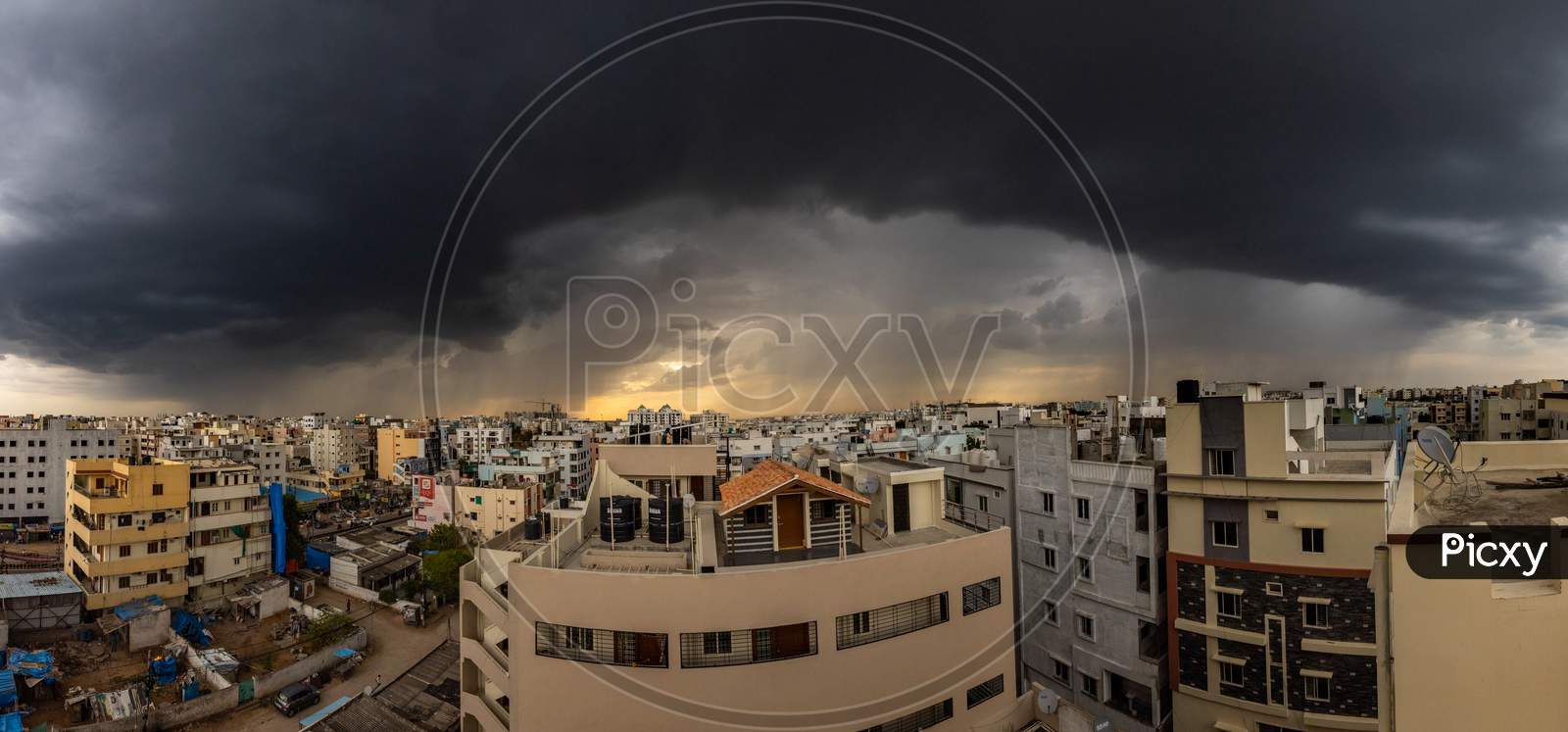 Panoramic View Of Dark Clouds Before Rain Over An Urban City Buildings in Hyderabad