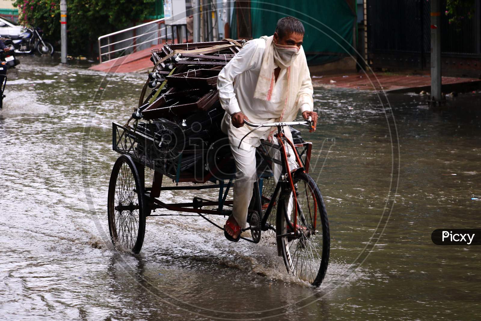 A Rickshaw Puller Rides On A Waterlogged Road During Rain, In Ajmer, Rajasthan, India On 04 June 2020.