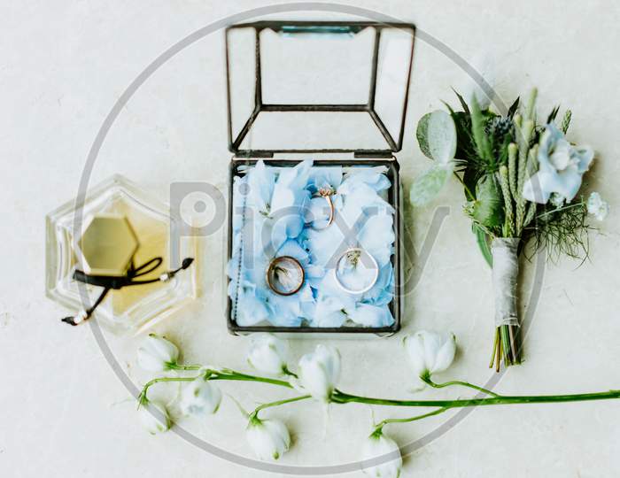 Wedding Ring And Flowers With Perfume Lay Flat