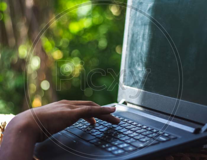 Businessman Using Laptop Computer And Working At Outdoor Park During Sunset Time. Using Laptop With Public Wifi.