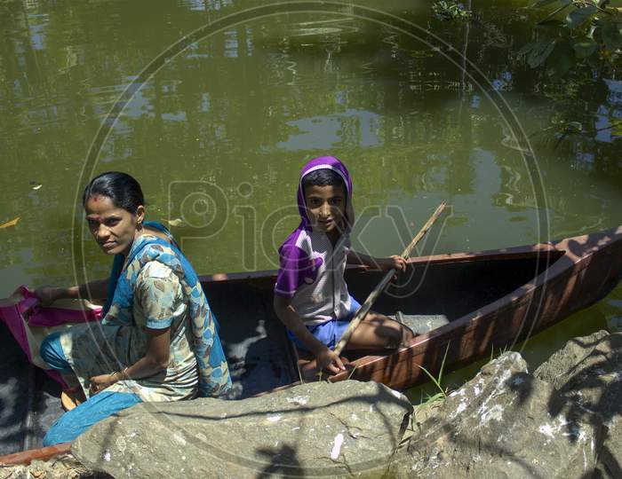 Allepey, India - March 11, 2014: A Boy With His Mother Traveling In Their Private Boat For Grocery Shopping