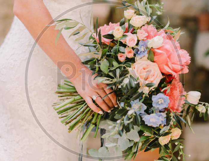 Bride Holding Wedding Bouquet In Fine Art Style