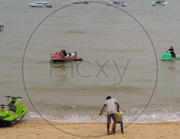 Pattaya,Thailand - April 30,2018: The Beach Tourists Relax And Swim There And Rent Boats For Trips.Some Thai People Sell Souvenirs,Food And Drinks To Them.