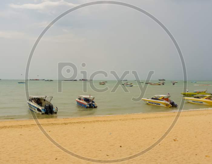 Pattaya,Thailand - April 17,2018: The Beach Tourists Relax And Swim There And Rent Boats For Trips.Some Thai People Sell Souvenirs,Food And Drinks To Them.