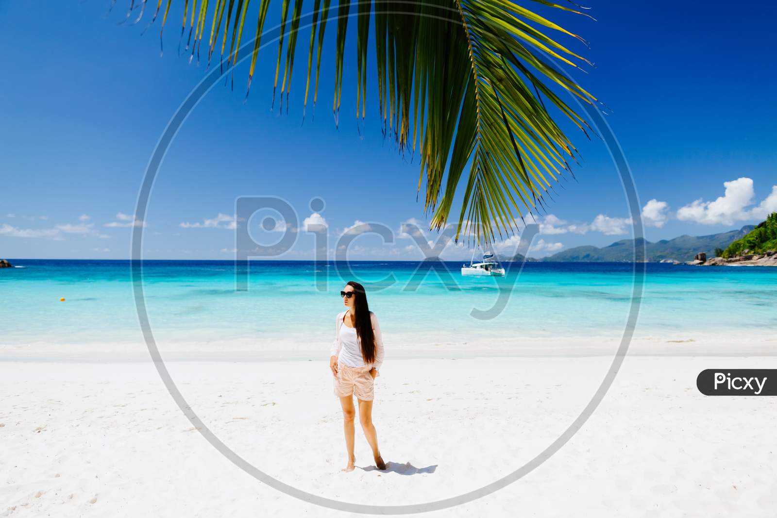 Woman Relax On Luxury Resort Beach With Palm Tree And Yacht Background