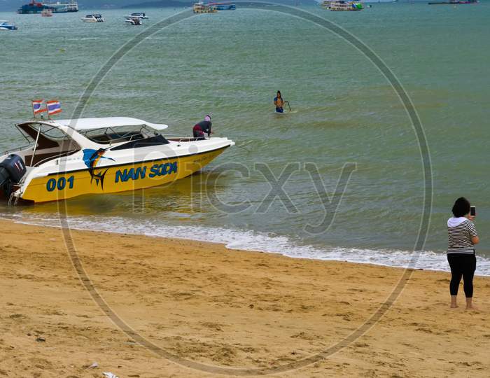Pattaya,Thailand - April 30,2018: The Beach Tourists Relax And Swim There And Rent Boats For Trips.Some Thai People Sell Souvenirs,Food And Drinks To Them.