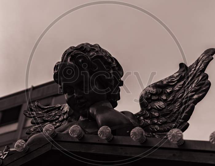 The Sculpture Of A Chistmas Angel On A Small Roof Top.