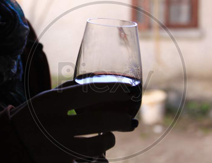 Hand Silhouette Holding Red Wine In Glass