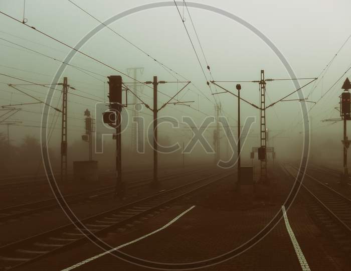 A Platform Of The Train Station Of A City On A Foggy Morning