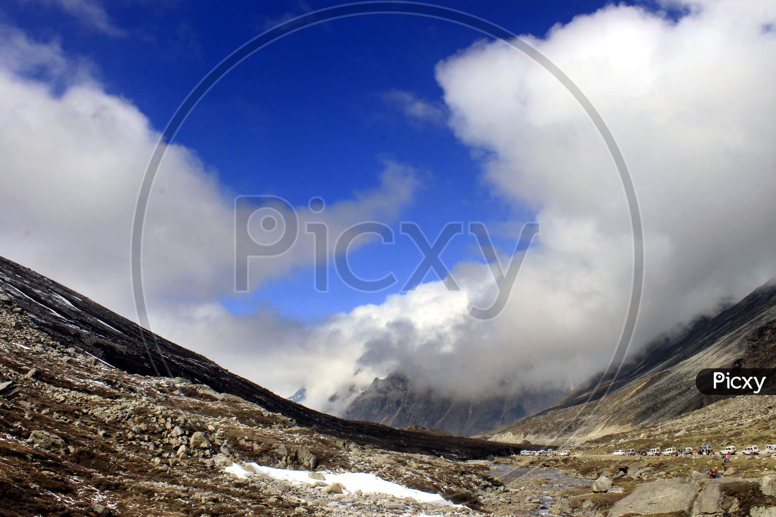 Snow Capped Mountains of Sikkim with Huge Clouds
