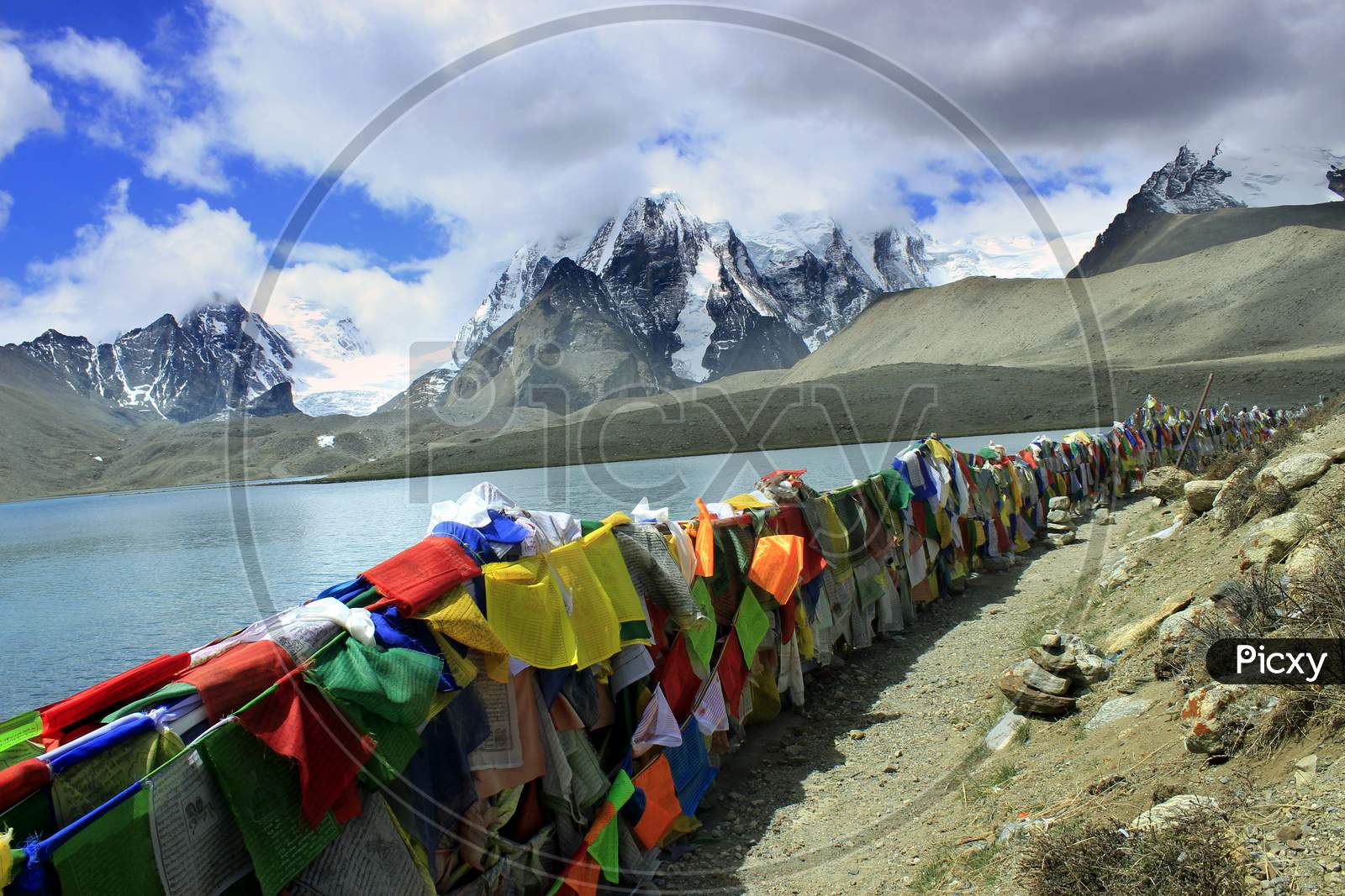 Tibetan prayer flags with Snow Capped Mountains on the Background