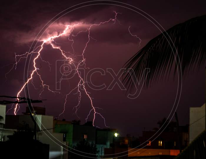 Lightning Storm Over The City Buildings. Lightning Bolt Strike During A Thunderstorm On Metropolitan City. Dark Sky With Bright Electrical Flash, Thunder And Thunderbolt, Bad Weather Concept