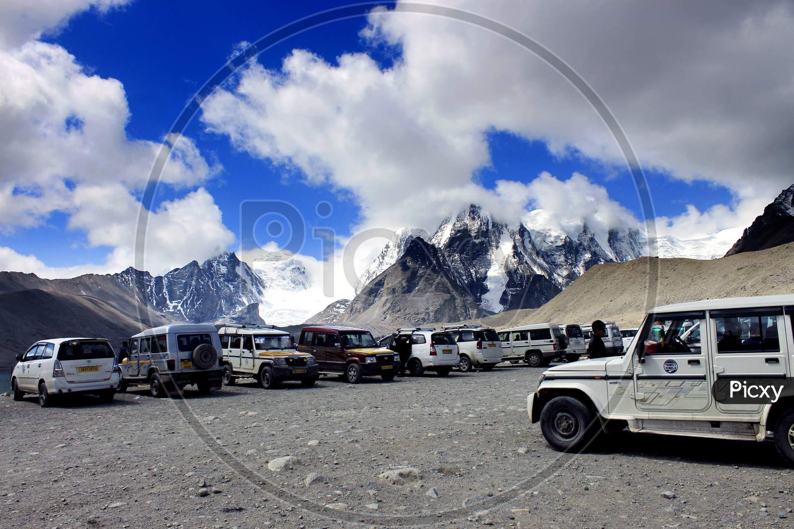 Snow Capped Mountains of Sikkim with Vehicles in the Foreground